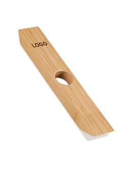 A light natural bamboo balancing wine bottle holder with a circular hole in the center and the word 'LOGO' printed on it, shown on a plain white background.