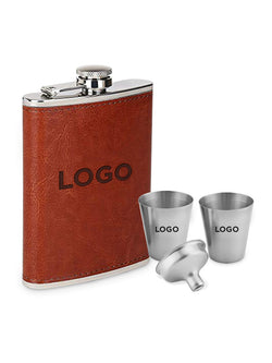 A brown leather flask with a silver metal cap and trim, shown with two matching stainless steel shot glasses and a small metal funnel. The items are printed with the placeholder text 'LOGO'.
