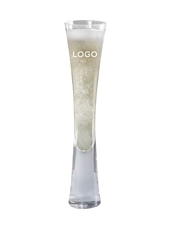 A tall, slender clear glass with a flared base, shown on a plain white background. The glass is filled with a pale golden bubbly liquid and has the word 'LOGO' printed near the top.