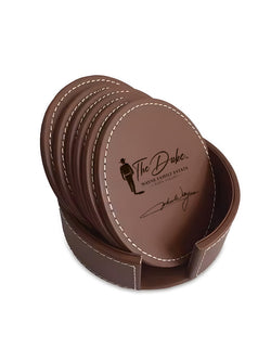 Set of brown leather coasters with a holder on a white background
