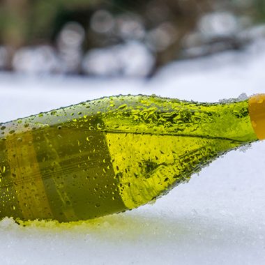 Wine bottle laying in snow