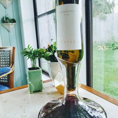 Bottle of Artisan 5 tipped into decanter