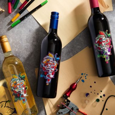 Suburban Fracas wine bottles, art pens, paper and tattoo gun