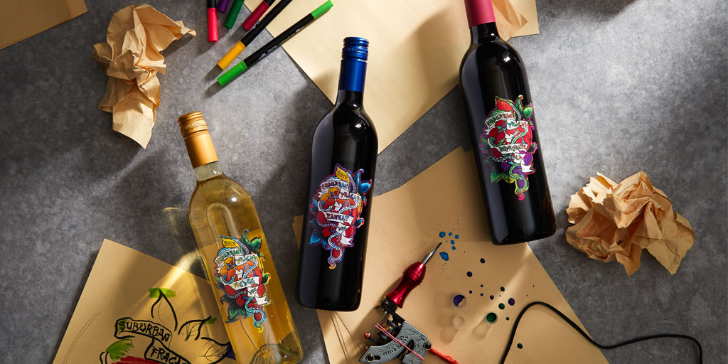 Suburban Fracas wine bottles, art pens, paper and tattoo gun