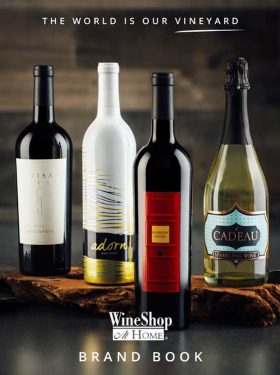Four bottles of WineShop At Home wines on a wooden backdrop