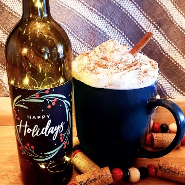 Christmas Morning Cheer cocktail - "Happy Holidays" wine bottle with lights inside, a coffe mug filled with whipped cream