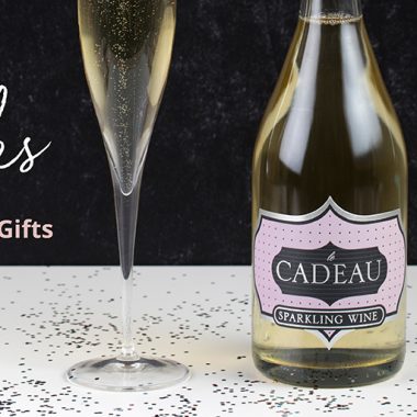 Bottle of sparkling wine, wine glass, confetti and the words "Our Picks for Holiday Gifts"