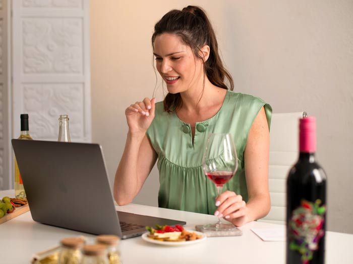 Solo woman enjoying a Corporate Virtual Tasting at home