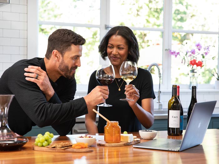 Couple in their kitchen enjoying a Virtual Wine Tasting