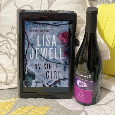 A bottle of Gemme Cellars 2018 Ruby on a bed next to a digital version of "Invisible Girl"