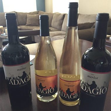 Four bottles of Adagio wine on a living room table