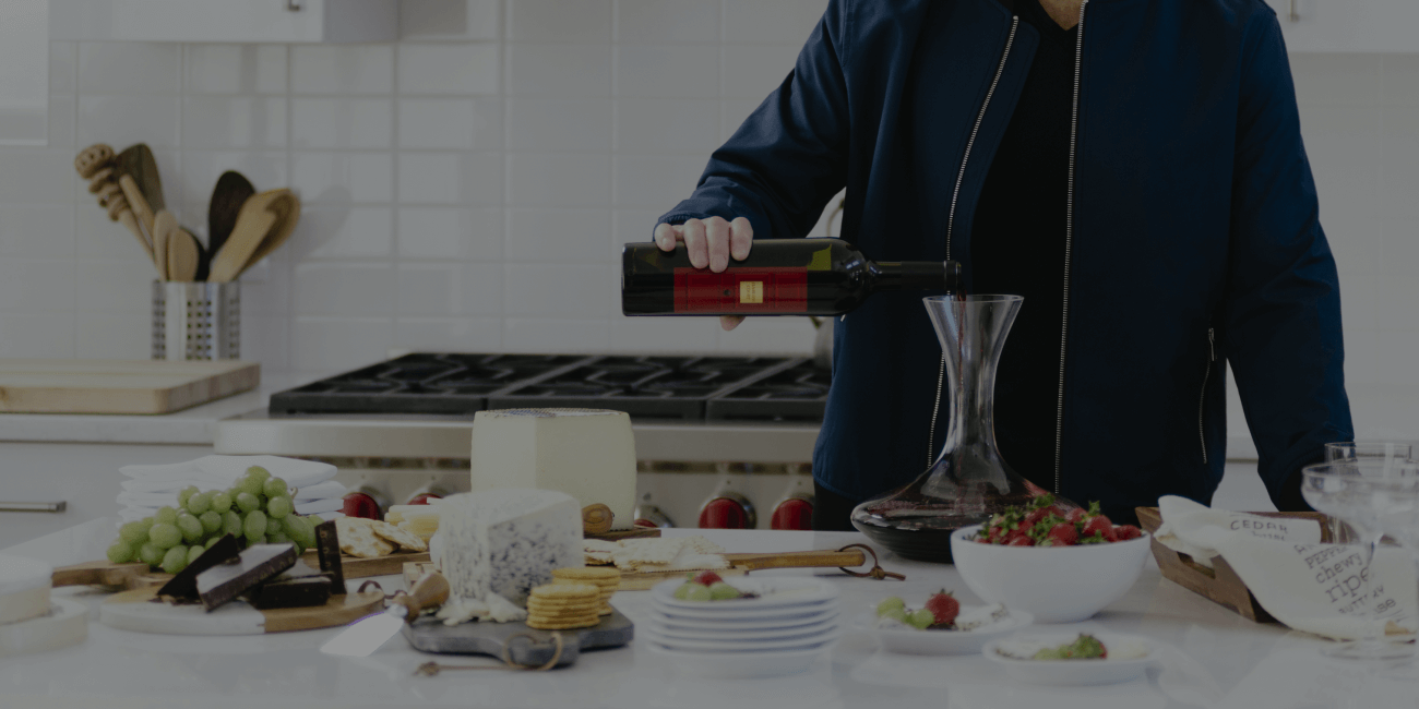 Man pouring wine in kitchen